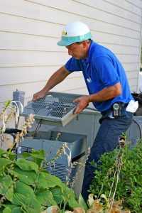 technician-servicing-air-conditioner