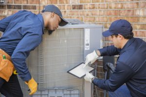 two-technicians-working-on-ac-outdoor-unit