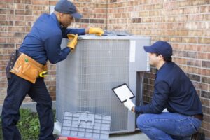 two-technicians-working-on-outdoor-ac-unit