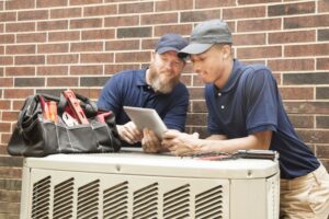 two-techs-working-on-ac-system