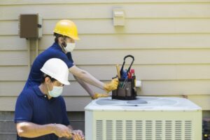 two-technicians-working-on-air-conditioner